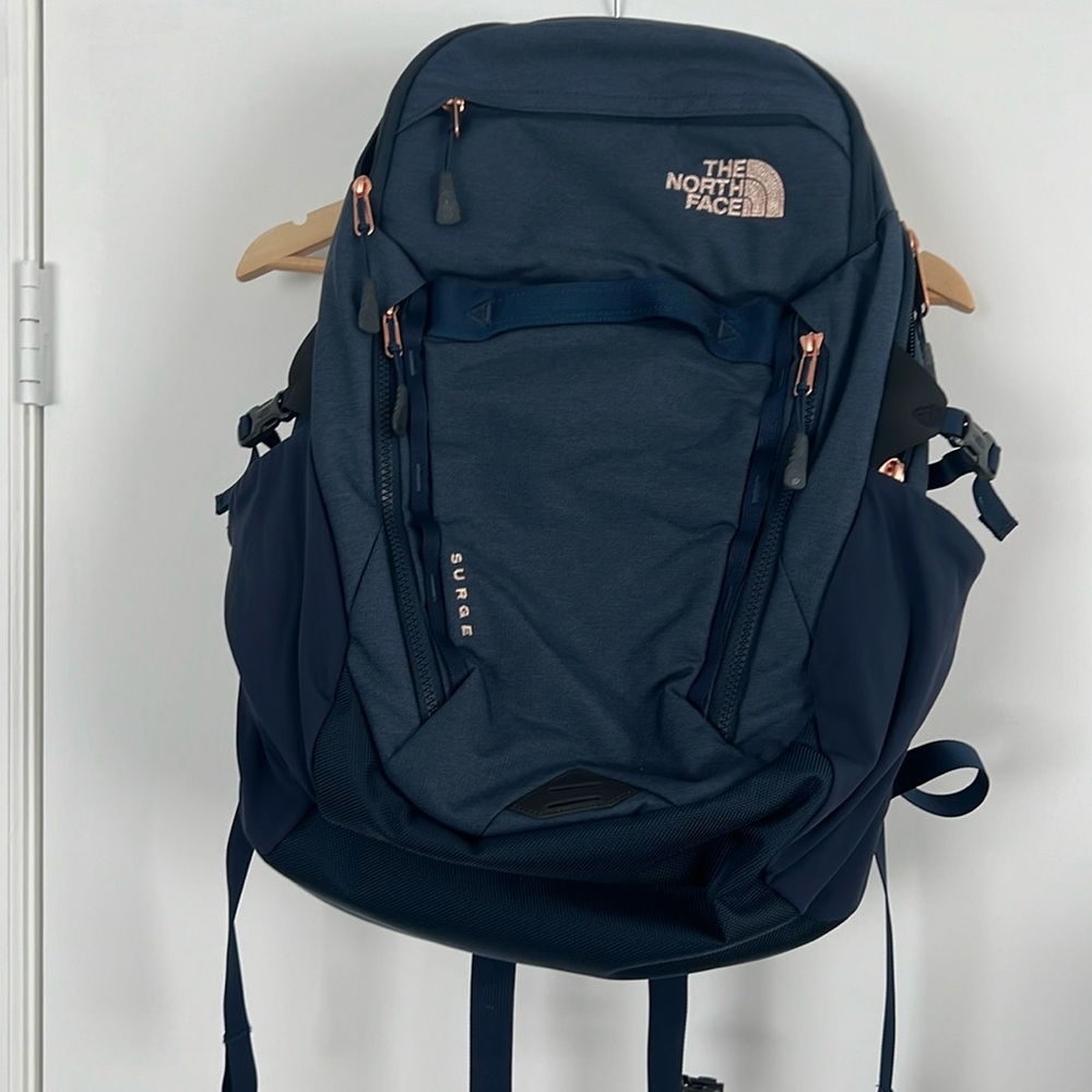 The North Face Surge backpack in navy with rose gold hardware